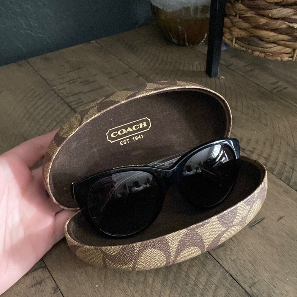 Black and clear Coach sunglasses with hard travel case